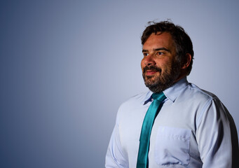 Portrait of a businessman wearing a green tie and looking ahead.