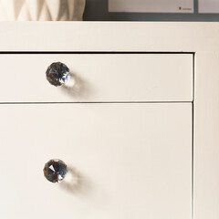Front view of white drawers of a decorative furniture for you bedroom or living room