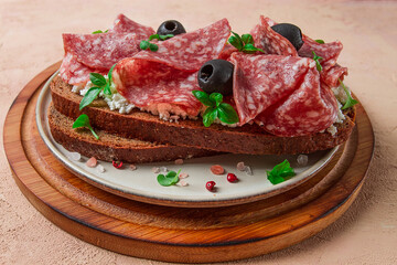 Sandwich , grain bread, with cream cheese and salami, black olives, micro-greens, top view, close-up, no people, Breakfast,