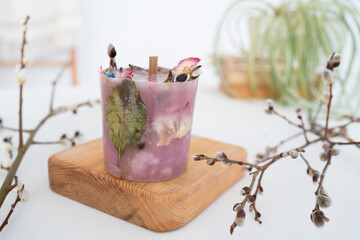 Craft candle with herbarium flowers