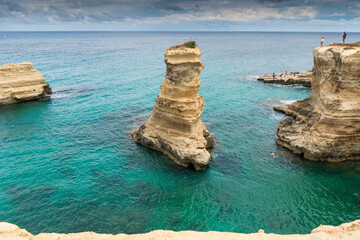 Fototapeta premium View at the Rock formation Faraglioni di Saint Andrea in Torre del Orso on the shores of the Adriatic Sea - Italy