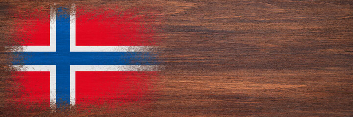 Fototapeta premium Flag of Norway. Flag is painted on a wooden surface. Wooden background. Plywood surface. Copy space. Textured background