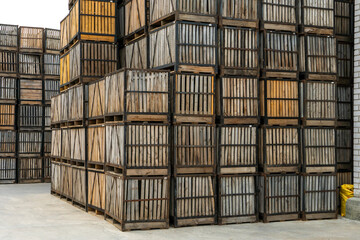 rows of wooden crates, crates and pallets for storing and transporting fruits and vegetables in the warehouse. production warehouse on the territory of the agro-industrial complex.
