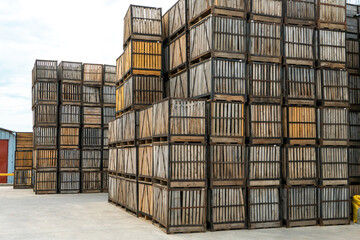 rows of wooden crates, crates and pallets for storing and transporting fruits and vegetables in the...