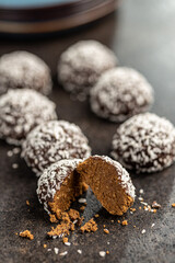 Coconut chocolate balls on kitchen table.