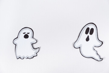 Funny charming ghosts with faces on a white background, top view