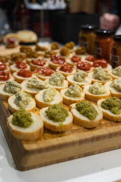 Slices of Italian Bread “Crostini” with Tomato, Herb and Other Vegetable Sauces