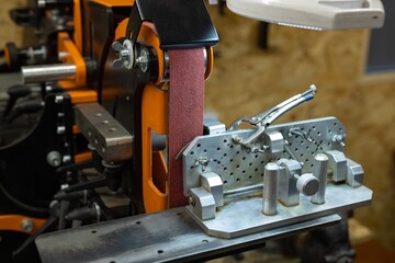 Large industrial belt sander in the workshop. Custom professional Rotating belt sander for knife...