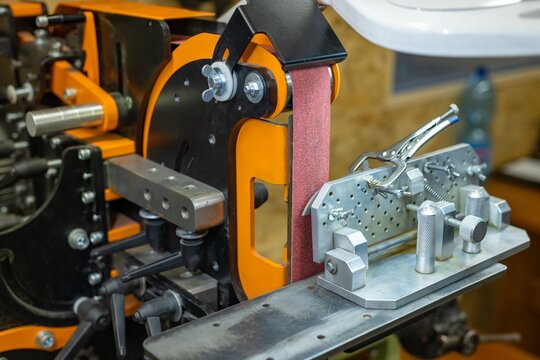 Large industrial belt sander in the workshop. Custom professional Rotating belt sander for knife production and metal processing.