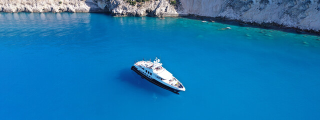 Aerial drone ultra wide panoramic photo of large luxury yacht anchored in paradise Mediterranean bay with turquoise crystal clear sea