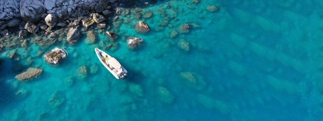 Fototapeta na wymiar Aerial drone top down photo of inflatable speed boat anchored in tropical exotic island