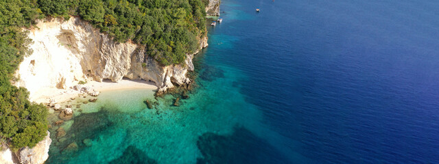 Aerial drone ultra wide panoramic photo of tropical Caribbean island bay with white sand beach and beautiful turquoise and sapphire clear sea forming a blue lagoon