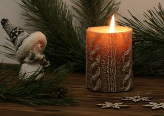 Christmas still life with candle and snowman toy