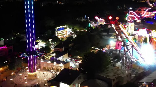 VIENNA, AUSTRIA - AUGUST 20, 2022: Aerial view of Prater Park night lights. Amusement city park on a summer night from drone