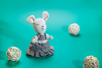 homemade sewn soft toy mouse on a turquoise background