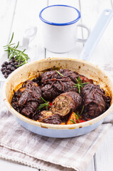 Traditional slow cooked German wagyu beef roulades with mushroom and vegetable served in spicy gravy sauce as close-up in an enamel pan