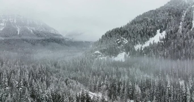 3d Snow Covered Mountain During Winter Stands High Above Valley Floor Where a Road Meanders Deep into the Unknown Forest