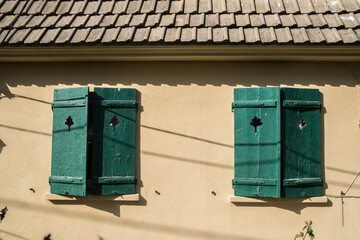 Detail of old vintage house with wooden window shutters
