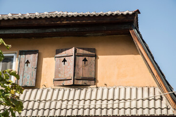 Detail of old vintage house with wooden window shutters