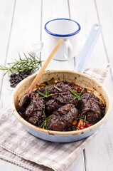 Traditional slow cooked German wagyu beef roulades with mushroom and vegetable served in spicy gravy sauce as close-up in an enamel pan