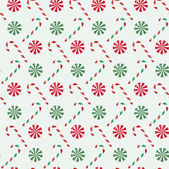 Seamless pattern with Christmas candy canes and mints on isolated background. Holiday design for wrapping paper, decoration, greeting card, and celebration of winter, Christmas or New Year.