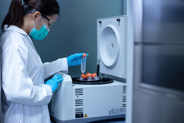 Researcher used the centrifuge machine to separate the DNA from the solution during DNA research.