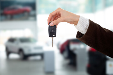 young sales woman giving car key