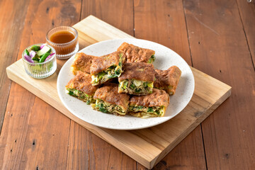 Indonesian Street Food Martabak Telur, Savory pan-fried pastry stuffed with egg, meat, green onion...