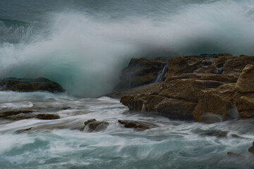 inspired haze. The brave ocean against the rocks. Waves