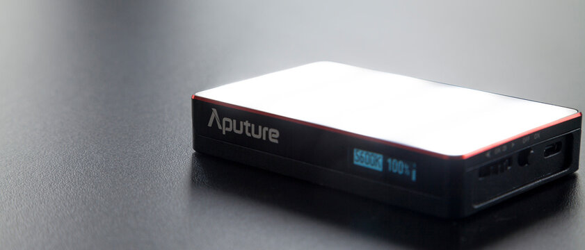Led aputure MC lit on top of a black table. Brightness of light. LED concept. Lighting concept.