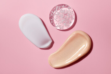 set of cosmetic make up and skincare swatches on pink background