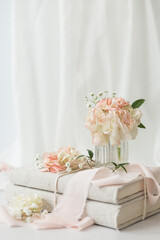 Small Bouquet of Pink Hydrangea on Stack of Linen Covered Books