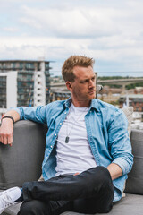 Fototapeta premium A young man sitting on a bench