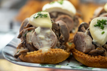 French mini quiche pie with goat cheese and traditional French sausage Andouillette from Troyes in bakery