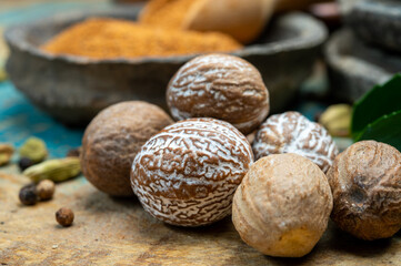 Nutmeg powder. Macro view whole nuts and grated muscat nuts on vintage background.