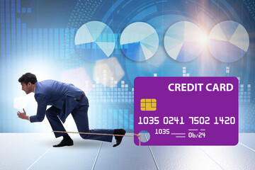 Businessman in the credit card debt concept