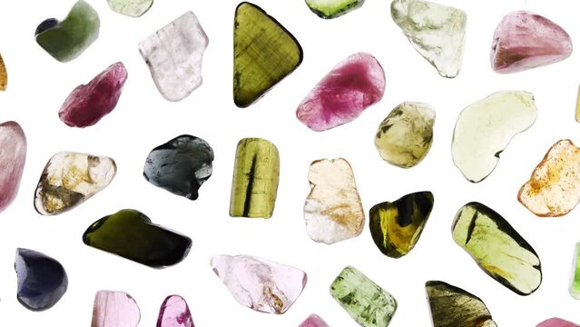 Tourmaline rare jewel stones texture on white light isolated background. Moving right seamless loop backdrop.