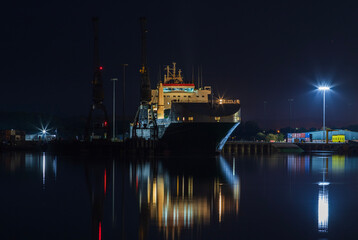 A docked cargo ship in the night