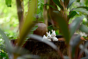 Closeup of Rabbits Stucco Doll with natural background for design and decoration in the garden at thailand.