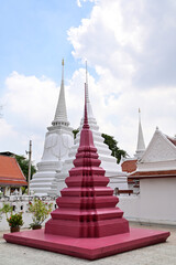 Fototapeta premium Closeup of White and Red Pagoda with blue sky and white cloud background at Buddha temple,Thailand.