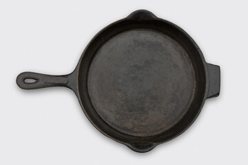 Cast iron frying pan or skillet on a plain background