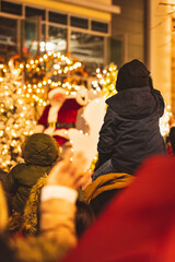 Child waving to santa	
