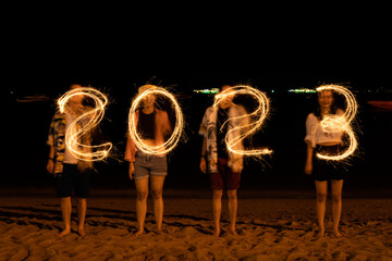 Happy New Year 2023.young friends having fun at New Year's Eve Party 2023 and Sparkling burning...