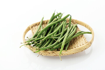 Pile of Raw Green Baby Fine Beans on a Rattan Tray Plate