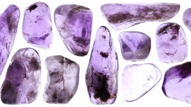 Isolated rutilated amethyst gemstones set texture. Moving right seamless loop backdrop.