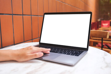 Mockup image of a woman using and touching on laptop computer touchpad with blank white desktop screen