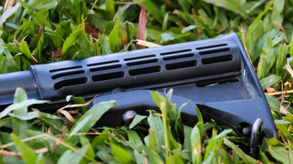 Air soft gun collapsible stock put on the grass