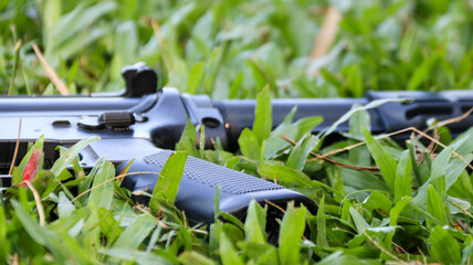 Air soft gun pistol grip put on the grass