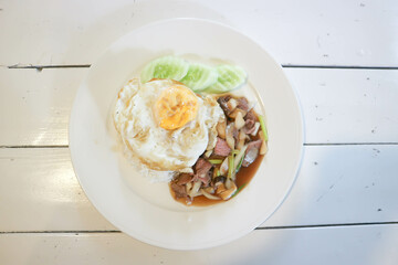 stir fried pork with vegetable , rice and sunny side up egg or stewed pork with egg and rice or stir fried mushroom