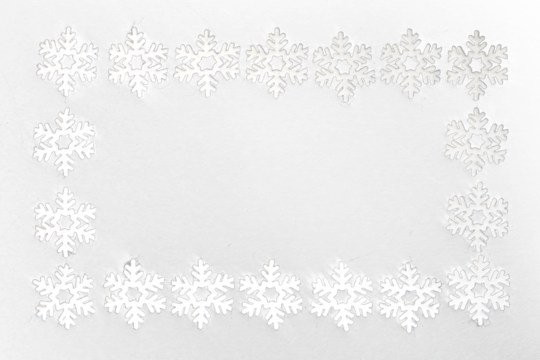 Frame of small white felt snowflakes, celebrating winter holidays
